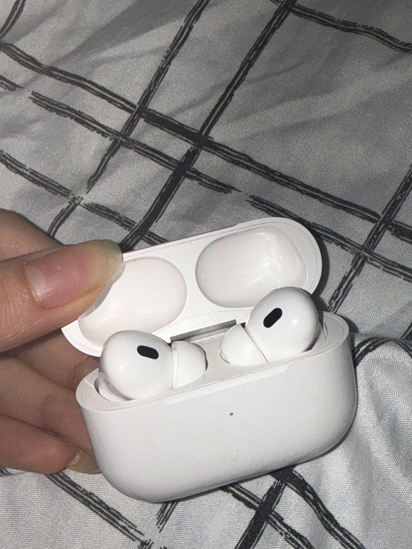 Apple AirPods Pro 2 (Category: Earphones) located in Angono. Submitted by xxxallaboutbagsxxx (Listing ID 1406938470, Image 1). Description: - Apple AirPods Pro with charging case - White color - Charging case with silver hinge and charging indicator light - Model number visible on the case - negotible!!.