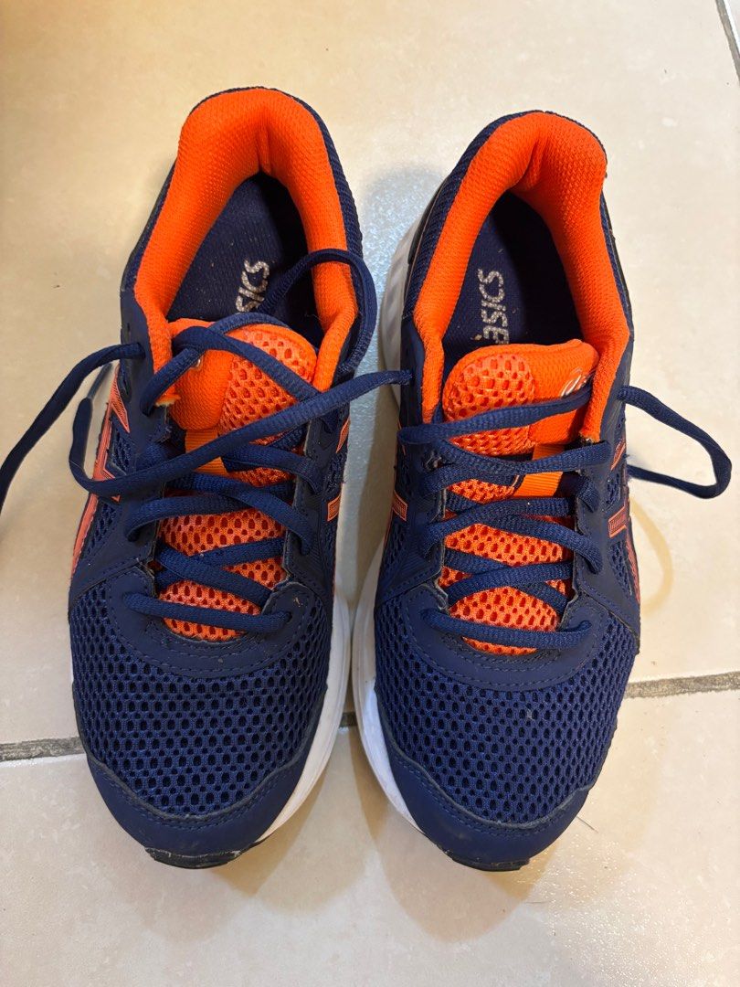 Asics Running Shoes - Navy Blue and Orange (Category: Sneakers) located in Quezon City. Submitted by gtancollection (Listing ID 1406835201, Image 3). Description: - Asics running shoes - Color: Navy blue and orange - Size: US 4, Euro 36 - Made in Cambodia - Features: Mesh upper, white sole, Asics logo - Condition: Some wear on soles - Ready to wear.