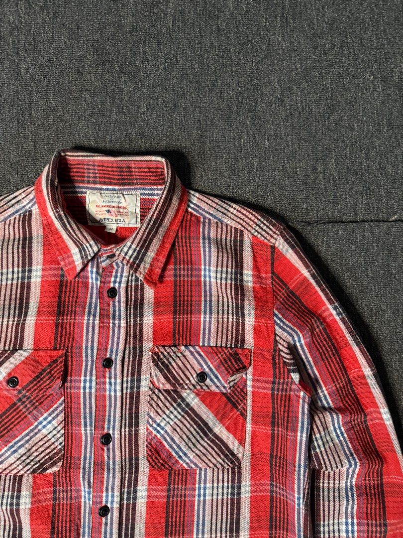 Avirex Plaid Flannel Shirt (Category: Tshirts & Polo Shirts ) located in San Marcelino. Submitted by SoloMain (Listing ID 1406877900, Image 3). Description: Authentic Avirex plaid flannel shirt. Features a classic red, white, and brown plaid pattern. Includes two chest pockets and a button-down front. The shirt is size M. There are washable stains on the bottom, but they are not very visible. Width is 20 inches and length is 26 inches..