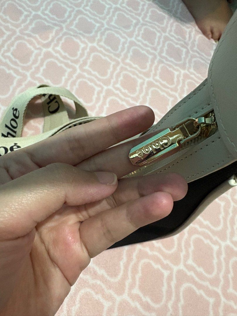 Chloe Shoulder Bag & Sling bag with Logo (Category: Luxury Bags & Wallets) located in Bulacan. Submitted by kyrieakira (Listing ID 1406949591, Image 2). Description: - Chloe shoulder & Sling bag - Black body with white logo - Cream-colored trim and strap - Gold zipper with Chloe logo - Spacious interior - Unique crescent shape - Once lang din ginamit - Super nice bagay sa lahat ng outfit.