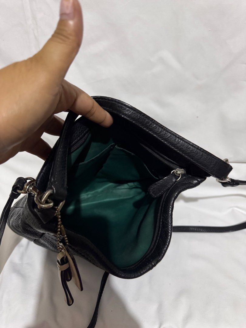 Coach Black Leather Crossbody Bag (Category: Luxury Bags & Wallets) located in Makati City. Submitted by tybexpress (Listing ID 1406989647, Image 3). Description: Decluttering! With chip on rubber lining but not noticeable since the bag is black - genuine all leather - needs cleaning inside pag maselan ka - Authentic Coach crossbody bag - Main compartment with green lining - Interior pocket - Detachable Coach tag - Top handle and adjustable strap