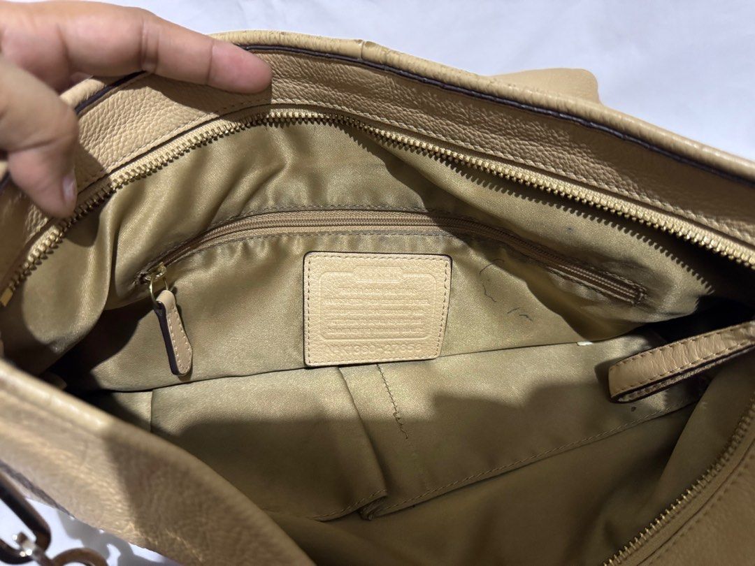 Coach Hobo Shoulder Bag (Category: Luxury Bags & Wallets) located in Makati City. Submitted by tybexpress (Listing ID 1406991620, Image 3). Description: Decluttering! - please refer to the pictures for flaws Bawal po sa maarte Inside needs cLeaning Pure leather - Authentic Coach hobo bag - Beige leather exterior - Top handle and shoulder strap - Secure zip closure - Fabric lining - Interior: slip pocket and zip pocket - Silver-toned hardware - Fe