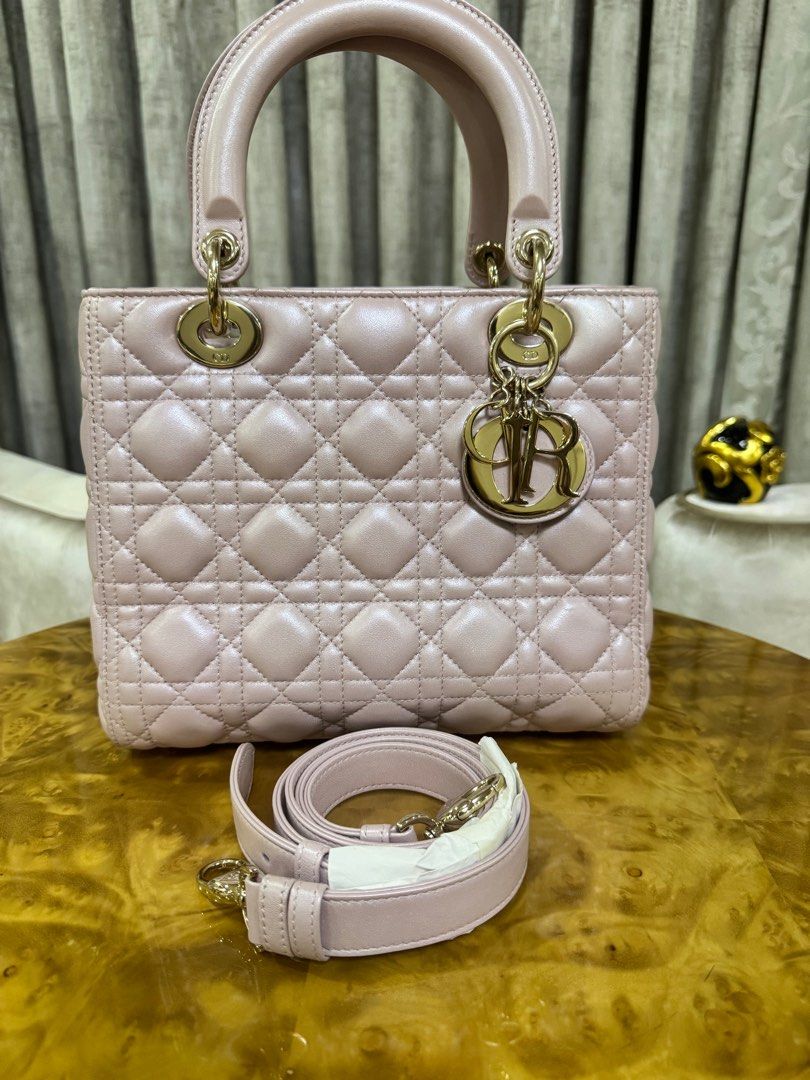 Dior Lady Dior Bag Medium Pearl Pink Authentic (Category: Luxury Bags & Wallets) located in Makati City. Submitted by happyprelovedph (Listing ID 1406855892, Image 1). Description: - Authentic Lady Dior handbag - Soft pink color - Iconic Cannage stitching - Gold-tone hardware - Detachable shoulder strap - Includes Dior dust bag and card - Spacious interior with zip closure - Top handle - Dior logo charm.