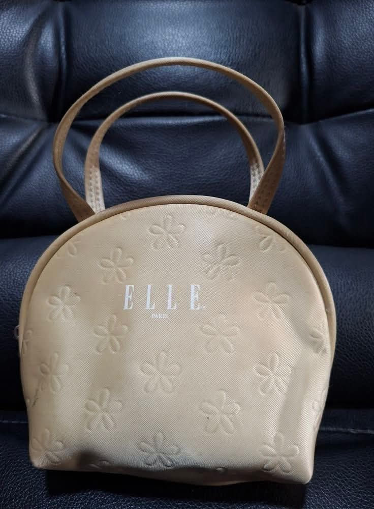 Elle Paris Handbag (Category: Luxury Bags & Wallets) located in Manila. Submitted by closetprincess (Listing ID 1406928472, Image 1). Description: - Elle Paris handbag - Beige exterior with floral pattern - Two handles - Zipper closure - Beige interior - Small size, ideal for cosmetics or small essentials - Stylish accessory for everyday use.
