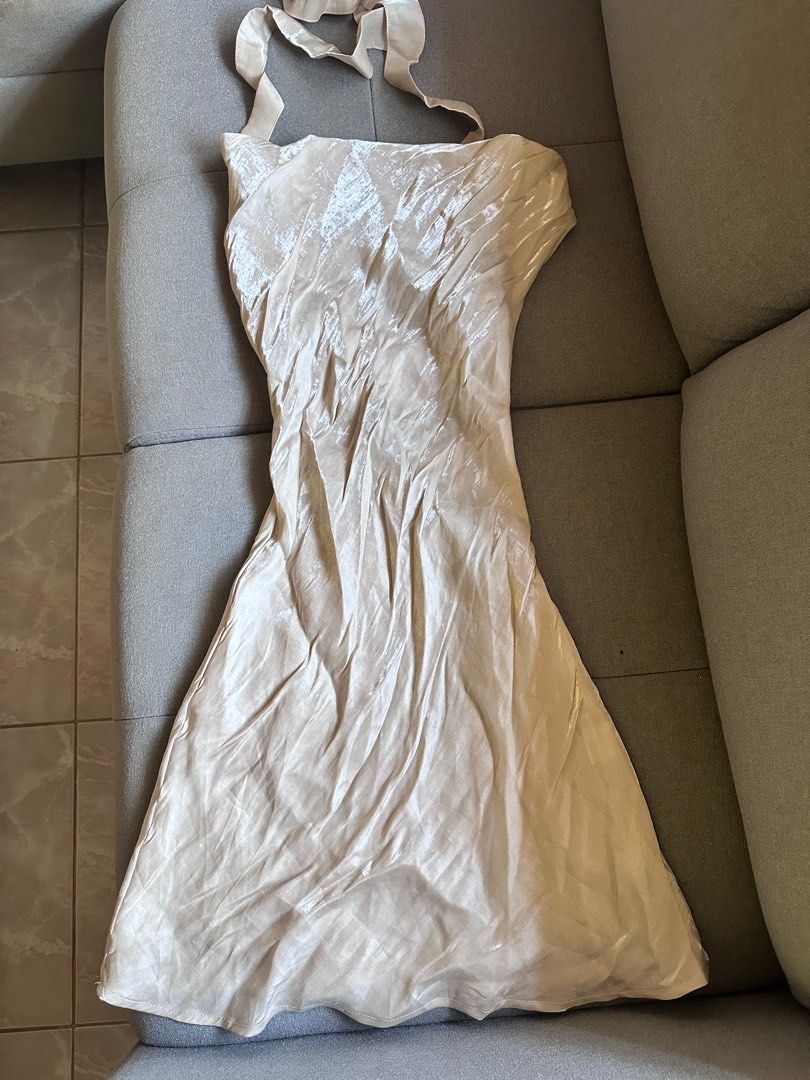 Iridescent Beige Halter Dress (Category: Dresses) located in Paranaque City. Submitted by dove.closet (Listing ID 1406834684, Image 1). Description: - Elegant beige halter dress - Flowing design - Flattering silhouette - Ideal for special events - Subtle sheen fabric.