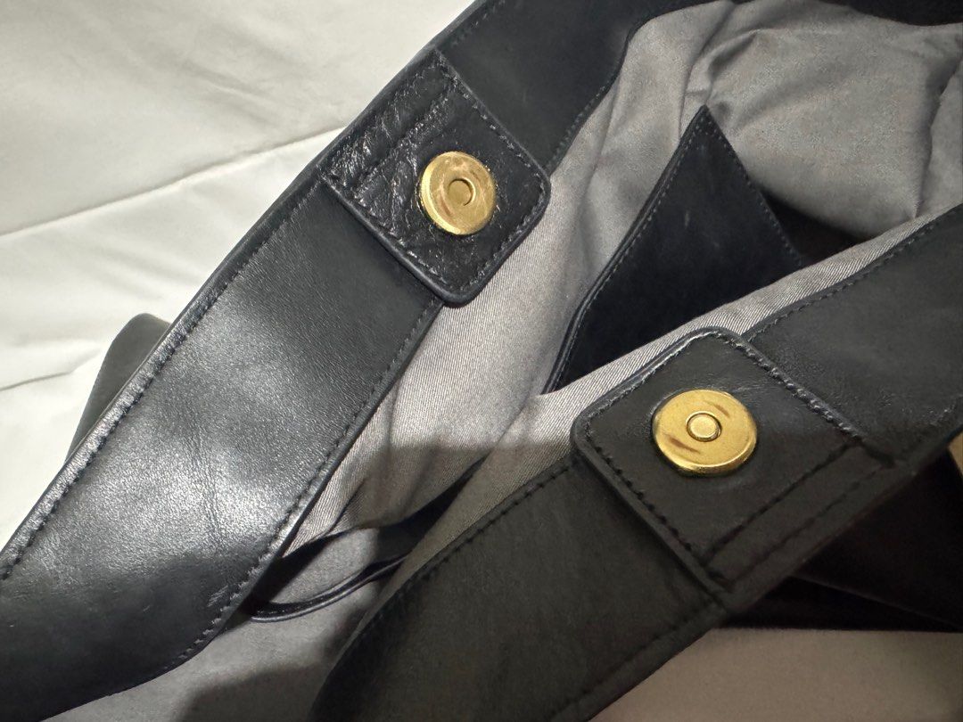 Joy Gryson Black Leather Tote Bag (Category: Tote Bags) located in Makati City. Submitted by tybexpress (Listing ID 1406989328, Image 3). Description: Decluttering! 18”x15” pure leather - Black leather tote bag by Joy Gryson - Gold-toned accents on top handles - Magnetic snap closure - Gray interior lining - Spacious design - Suitable for everyday use - Joy Gryson logo visible.