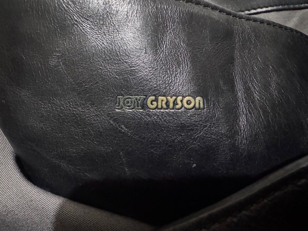 Joy Gryson Black Leather Tote Bag (Category: Tote Bags) located in Makati City. Submitted by tybexpress (Listing ID 1406989328, Image 2). Description: Decluttering! 18”x15” pure leather - Black leather tote bag by Joy Gryson - Gold-toned accents on top handles - Magnetic snap closure - Gray interior lining - Spacious design - Suitable for everyday use - Joy Gryson logo visible.