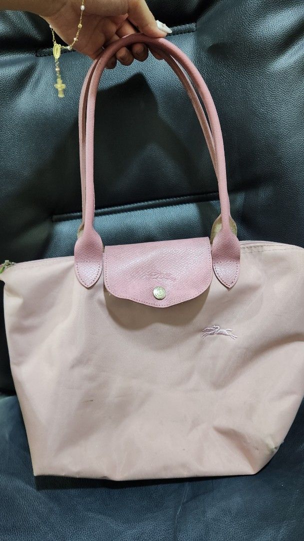 Longchamp Le Pliage Handbag (Category: Luxury Bags & Wallets) located in Manila. Submitted by summerstyled (Listing ID 1406958408, Image 1). Description: - Authentic pink Longchamp Le Pliage handbag - Top handle design - Secure flap closure - Interior label included - Zipper closure for added security - Spacious interior for your essentials.