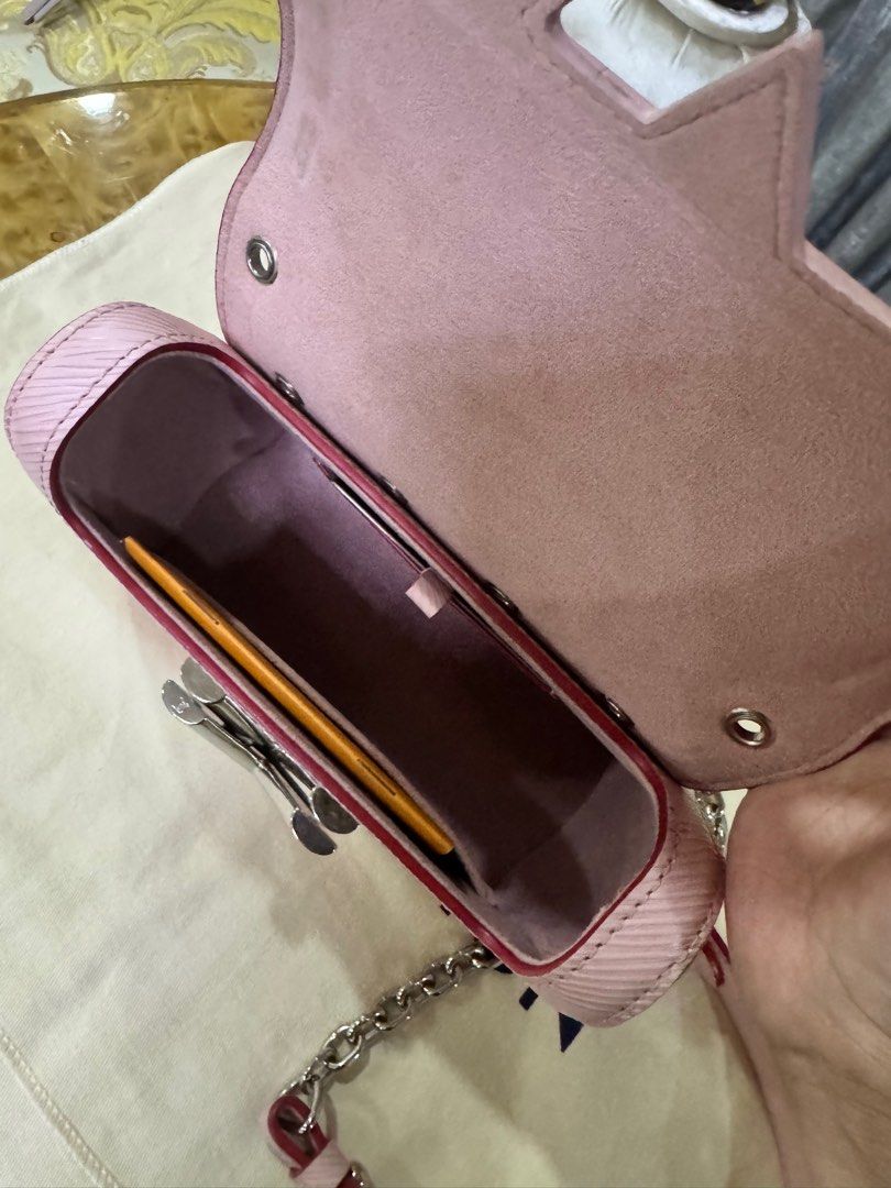 Louis Vuitton Twist Pink Epi Leather Bag Authentic (Category: Luxury Bags & Wallets) located in Makati City. Submitted by happyprelovedph (Listing ID 1406856609, Image 2). Description: - Authentic Louis Vuitton Twist Bag - Pink Epi Leather Exterior - Silver-Tone Hardware - Chain Strap - Signature LV Twist Lock - Includes Dust Bag, Tag, and Booklet - Matching Pink Interior Lining - Structured Shape with Studded Details.