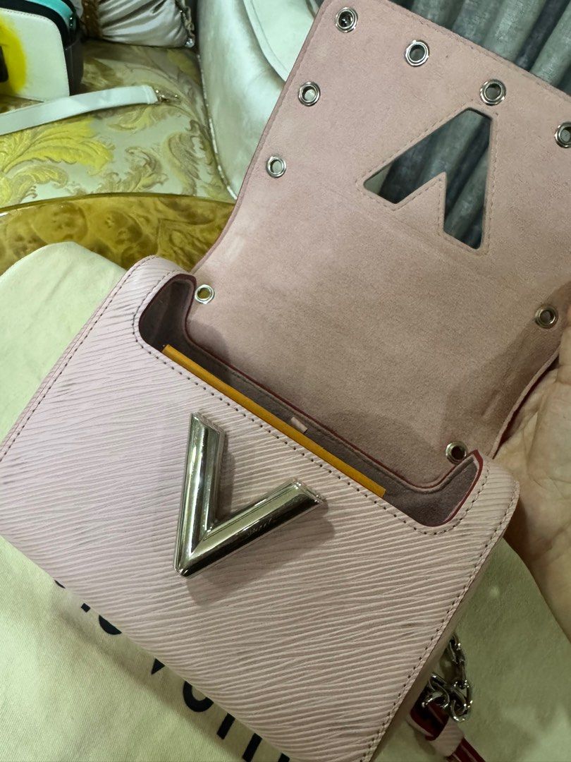 Louis Vuitton Twist Pink Epi Leather Bag Authentic (Category: Luxury Bags & Wallets) located in Makati City. Submitted by happyprelovedph (Listing ID 1406856609, Image 3). Description: - Authentic Louis Vuitton Twist Bag - Pink Epi Leather Exterior - Silver-Tone Hardware - Chain Strap - Signature LV Twist Lock - Includes Dust Bag, Tag, and Booklet - Matching Pink Interior Lining - Structured Shape with Studded Details.