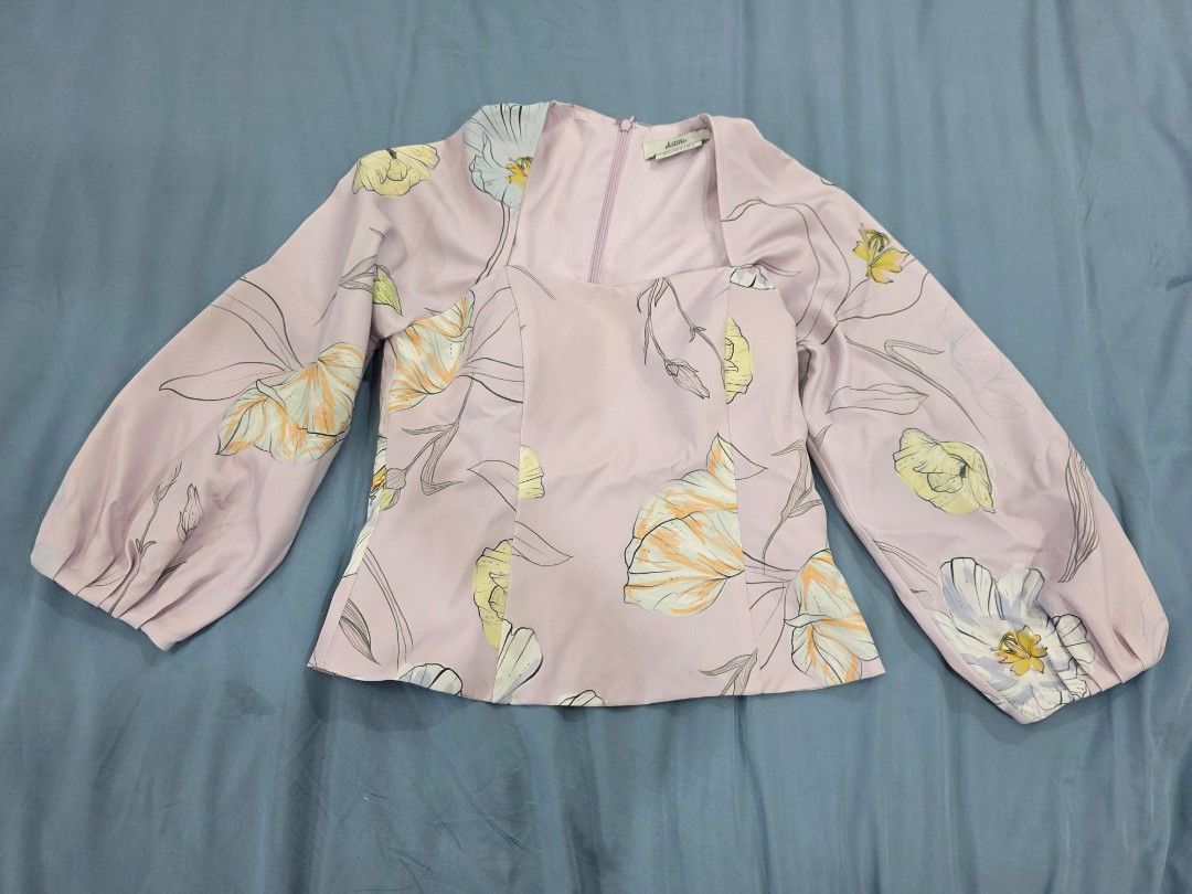 Love Bonito Floral Print Blouse (Category: Blouses) located in Imus. Submitted by mjsj1 (Listing ID 1406814726, Image 1). Description: Blouse features a square neckline and long, puffy sleeves. It has a light pink base color with a floral print in yellow and white. The blouse has a zipper closure at the back..