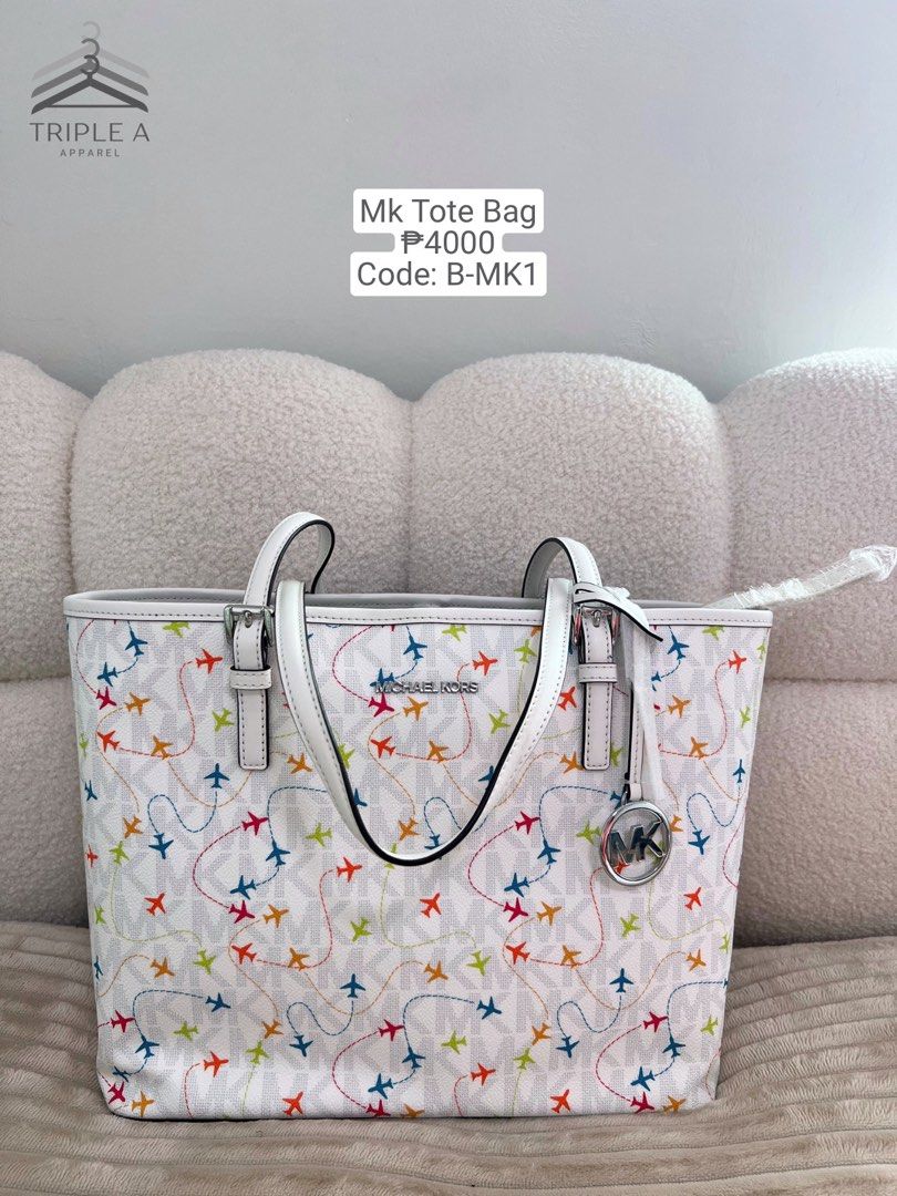 Michael Kors Jet Set White Medium Carryall Tote Bag (Category: Luxury Bags & Wallets) located in Valenzuela. Submitted by theasywn (Listing ID 1406857232, Image 1). Description: - Authentic Michael Kors tote bag - Features a vibrant airplane print - White handles and silver MK charm .