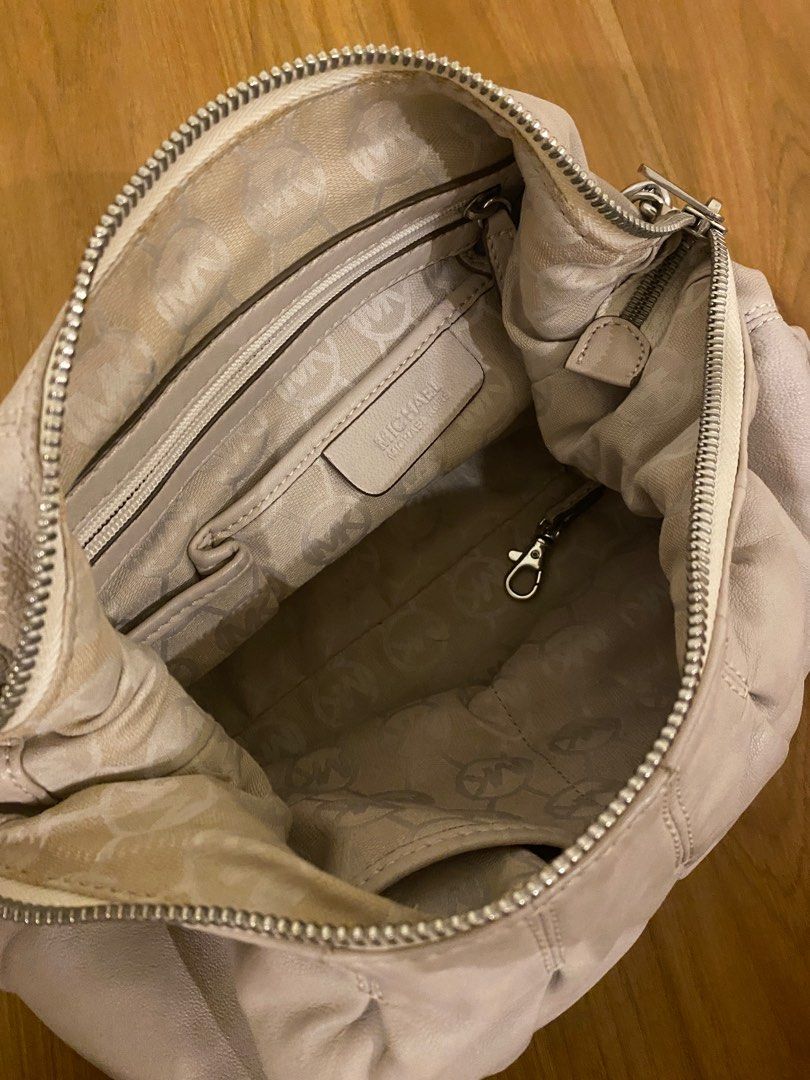 Michael Kors Shoulder Bag with Chain Strap (Category: Luxury Bags & Wallets) located in Cavite. Submitted by mfrancecloset (Listing ID 1406903121, Image 3). Description: - Authentic Michael Kors shoulder bag - Features: - Chain strap - Zip closure - Top handle - MK logo charm - Exterior: Light beige - Hardware: Silver-tone - Interior: - Zip pocket - Logo-printed lining.