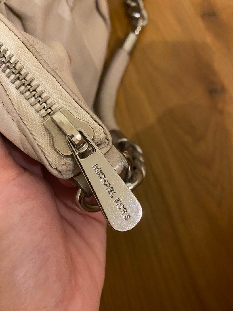 Michael Kors Shoulder Bag with Chain Strap (Category: Luxury Bags & Wallets) located in Cavite. Submitted by mfrancecloset (Listing ID 1406903121, Image 2). Description: - Authentic Michael Kors shoulder bag - Features: - Chain strap - Zip closure - Top handle - MK logo charm - Exterior: Light beige - Hardware: Silver-tone - Interior: - Zip pocket - Logo-printed lining.