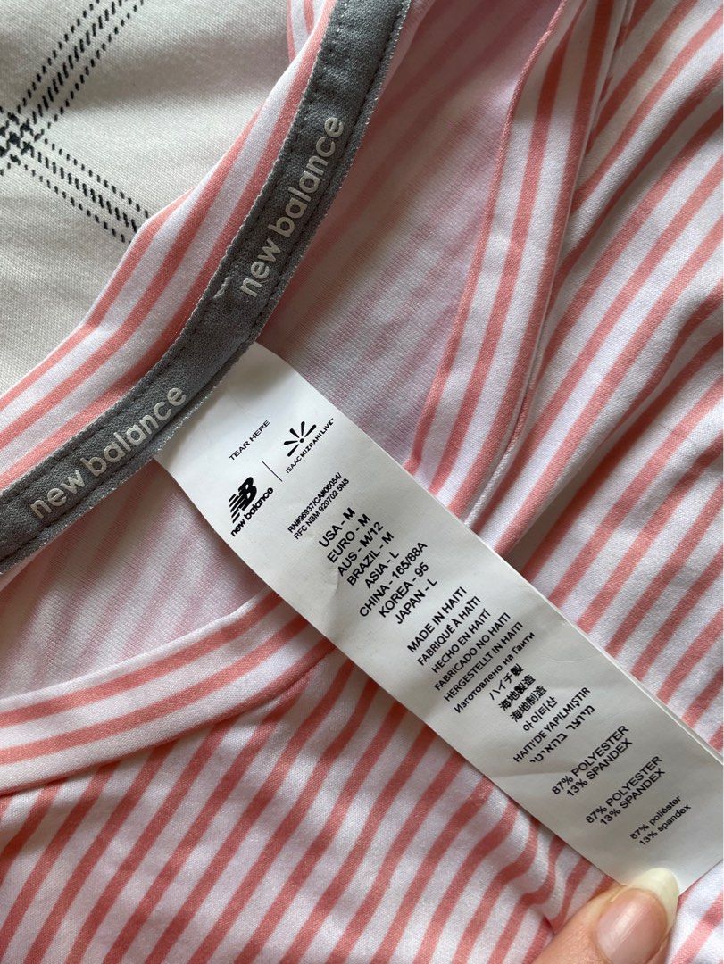 Authentic New Balance Striped Active Top - with original tag (Category: Activewear) located in Mandaue City. Submitted by midnight.skyes (Listing ID 1406901854, Image 3). Description: - New Balance striped tee - Color: Pink and white - Size: USA M / Asia L (width: 17.5in, length: 28in) - Features: Crew neck, short sleeves, curved hem, ruched detail - Thin, lightweight, soft material (87% polyester, 13% spandex) - Includes original tags.