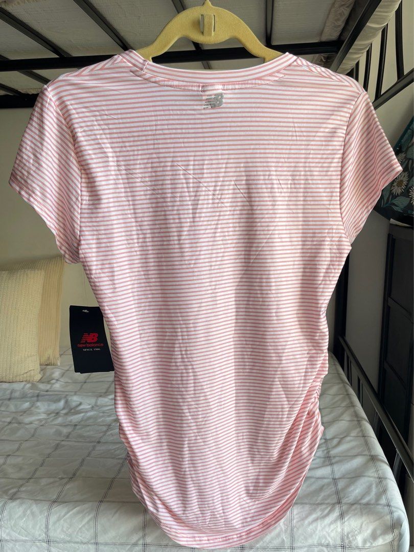 Authentic New Balance Striped Active Top - with original tag (Category: Activewear) located in Mandaue City. Submitted by midnight.skyes (Listing ID 1406901854, Image 2). Description: - New Balance striped tee - Color: Pink and white - Size: USA M / Asia L (width: 17.5in, length: 28in) - Features: Crew neck, short sleeves, curved hem, ruched detail - Thin, lightweight, soft material (87% polyester, 13% spandex) - Includes original tags.