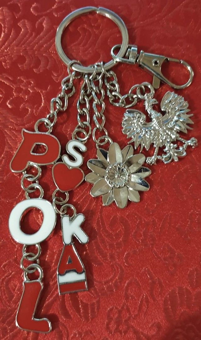 Poland Key Chain (Category: Charms) located in Taytay. Submitted by armyborahe21 (Listing ID 1406861038, Image 1). Description: Key chain features charms spelling out "POLSKA" with a heart, a flower, and a Polish eagle emblem. It has a silver-colored chain and clasp. The letters are red and white. It is a perfect souvenir or a gift for someone who loves Poland..