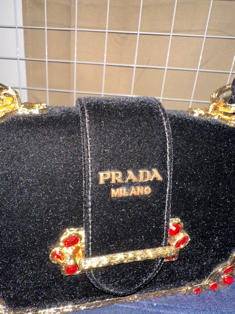 Prada Velvet Cahier Mini Bag (Category: Luxury Bags & Wallets) located in Taguig. Submitted by jthnl (Listing ID 1406907118, Image 3). Description: - Prada mini bag - Black velvet - Gold-tone chain strap - Gold and red jewel accents - Prada label inside - Made in Italy.