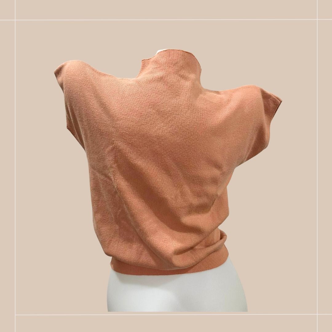 Pre-loved Peach Knitted Mock Turtleneck Top (Category: Others Tops) located in Quezon City. Submitted by simpleretiree (Listing ID 1406955220, Image 2). Description: This pre-loved peach-colored knitted top is still in good condition. Its features are as follows: - Mock neck design - Extended sleeves - Finely ribbed texture - Fitted silhouette - Versatile style Measurements (Higher numbers are the moderately-stretched size): Shoulder (end-to-end)