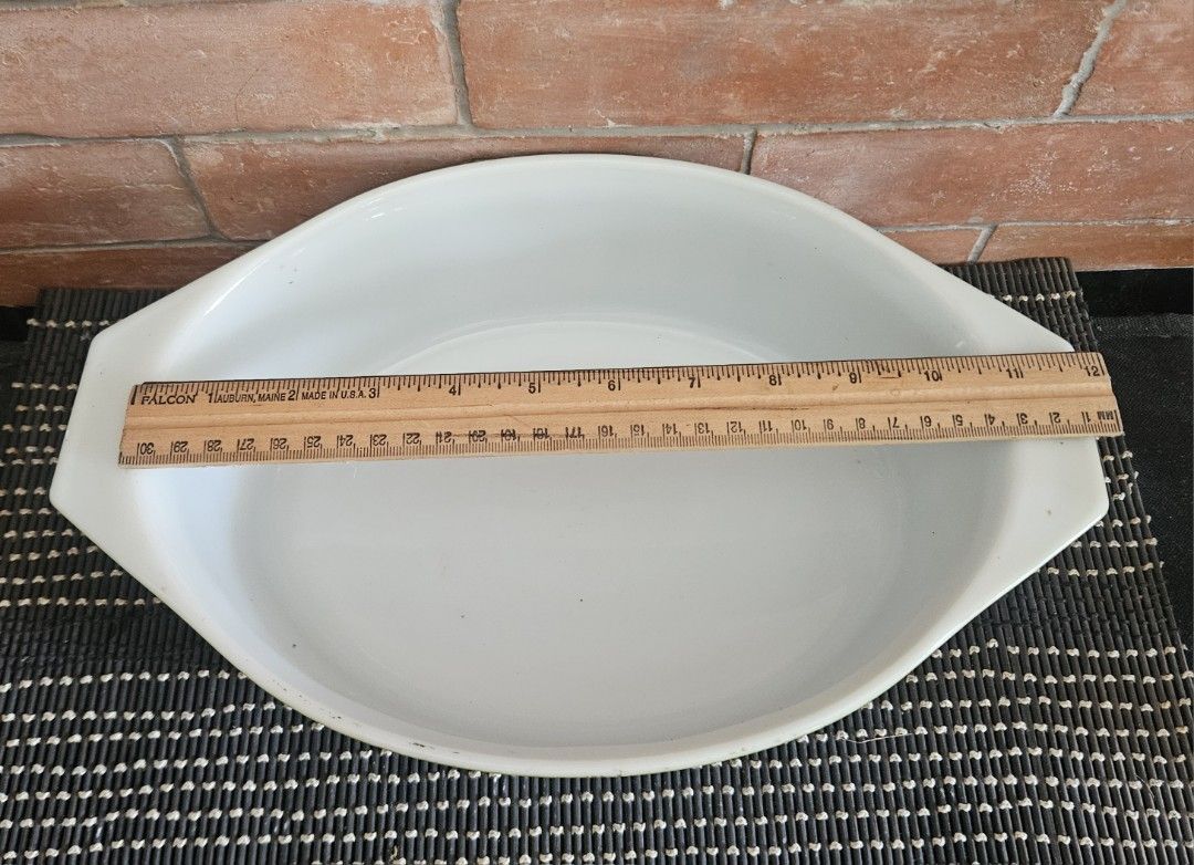 Pyrex 2.5 Qt Ovenware Baking Dish (Category: Bakeware) located in Rizal. Submitted by cherry_garcia (Listing ID 1406932644, Image 3). Description: - Vintage Pyrex baking dish - 2.5 Qt capacity - Made in the USA - Unique green and white color scheme - Textured green exterior - White interior - Oven-safe - Features handles.