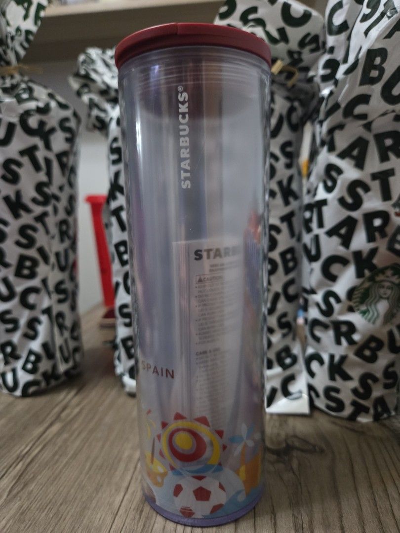 Starbucks Spain Tumbler (Category: Water Bottles & Tumblers) located in Manila. Submitted by sterling_grace (Listing ID 1406907372, Image 3). Description: - Starbucks Spain Travel Tumbler - Red lid, clear body - Features a design with sun, soccer balls, and fireworks - "SPAIN" printed on the side - Travel tumbler.