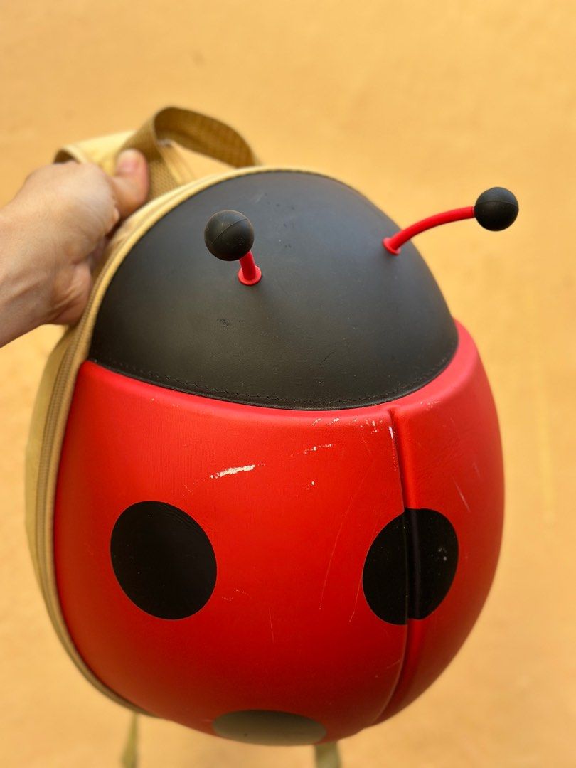 Supercute Ladybug Backpack (Category: Other Babies Going Out Needs) located in Batangas. Submitted by enyahsnivl56498 (Listing ID 1406881817, Image 1). Description: - Adorable ladybug design - Red body with black spots - Black head with antennae - Zippered closure - Adjustable straps - Interior: Mesh pocket and main compartment - Made in China.