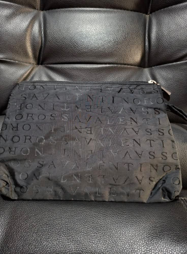 Valentino Clutch Bag (Category: Luxury Bags & Wallets) located in Manila. Submitted by closetprincess (Listing ID 1406929066, Image 1). Description: - Black Valentino clutch bag - Embossed Valentino logo - Rectangular shape - Zipper closure - Includes wrist strap.