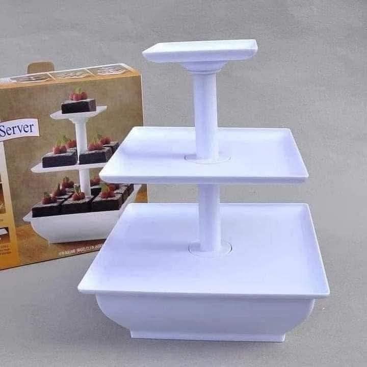 3-Tier Square Cake Server (Category: Other Kitchenware & Tableware) located in Manila. Submitted by yzlshop (Listing ID 1402097706, Image 2). Description: 3-tier cake server is perfect for displaying cupcakes, fruits, or other treats. It has a square design and is white. The server is ideal for parties, events, or everyday use. It is easy to assemble and disassemble for storage. The stand is made of durable material and is easy to clean..