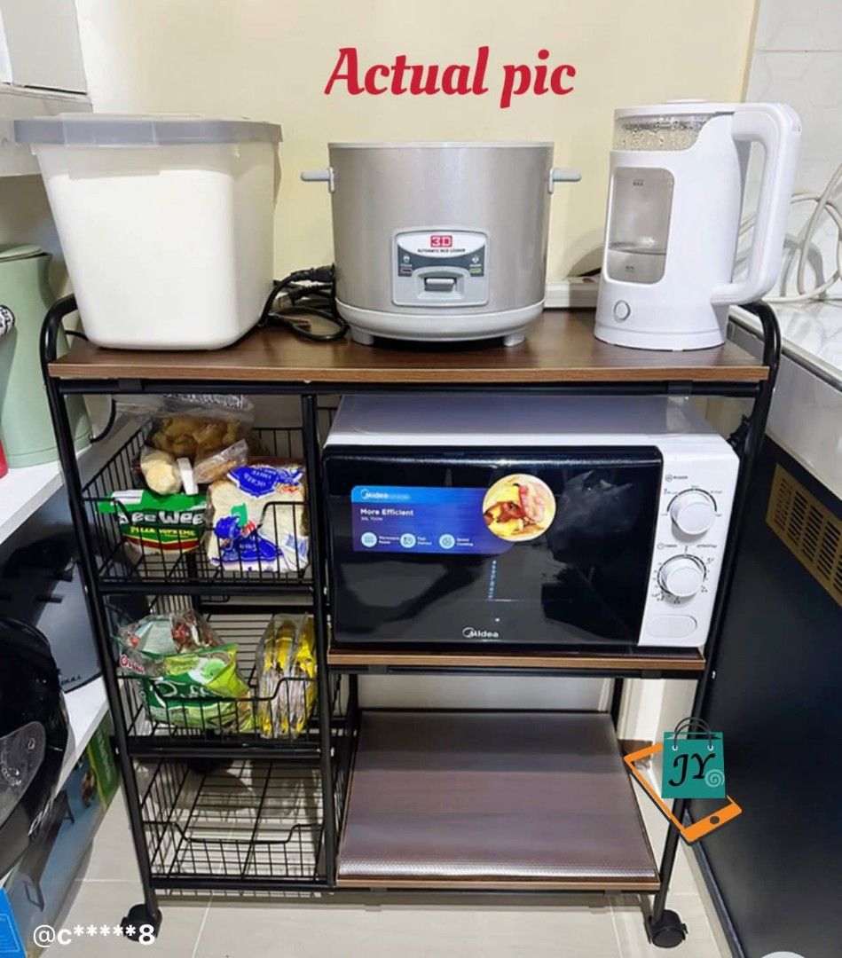 4-Layer Kitchen Storage Rack with Wheels (Category: Storage Boxes & Baskets) located in Manila. Submitted by jelai.cybyb (Listing ID 1402047929, Image 3). Description: Versatile 4-layer storage rack is perfect for organizing your kitchen, living room, bedroom, or study. It features a walnut-colored wood board design with a sturdy black metal frame. Includes three wire baskets for additional storage. The rack is equipped with four wheels for easy 