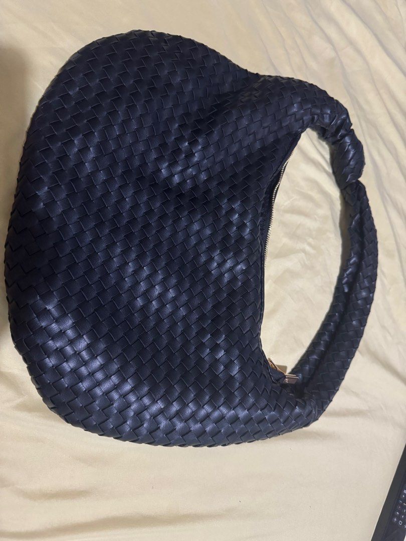 Black Woven Shoulder Bag (Category: Shoulder Bags) located in Quezon City. Submitted by sassi (Listing ID 1401968460, Image 2). Description: - Black woven leather shoulder bag - Zip closure - Braided handle - Gold-colored zipper - Rounded shape.