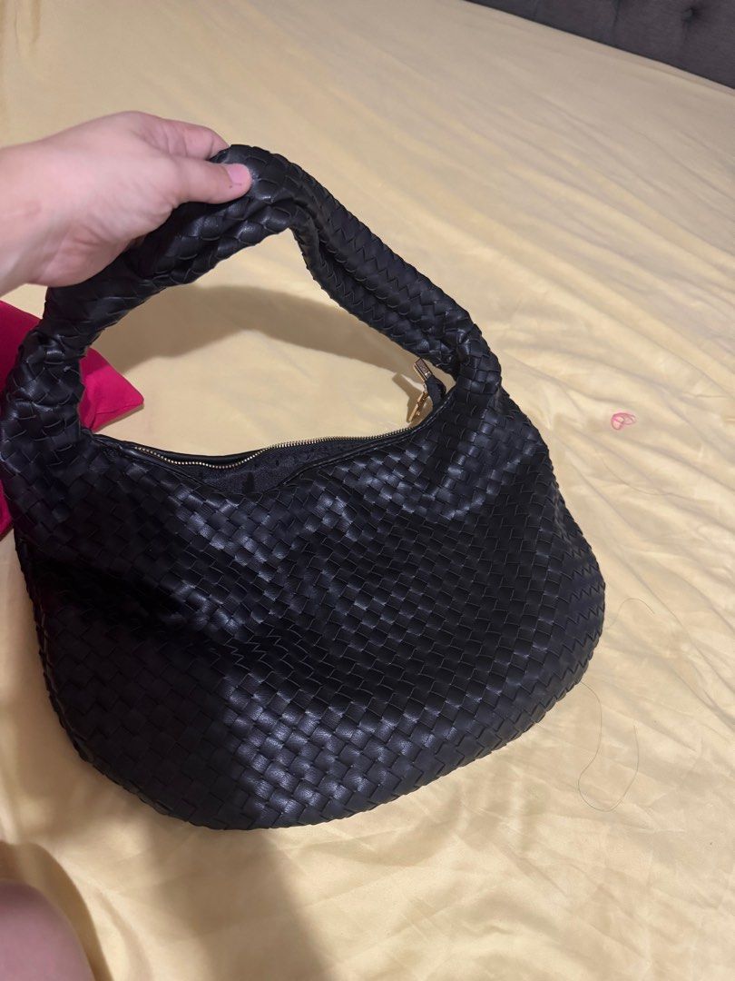 Black Woven Shoulder Bag (Category: Shoulder Bags) located in Quezon City. Submitted by sassi (Listing ID 1401968460, Image 1). Description: - Black woven leather shoulder bag - Zip closure - Braided handle - Gold-colored zipper - Rounded shape.