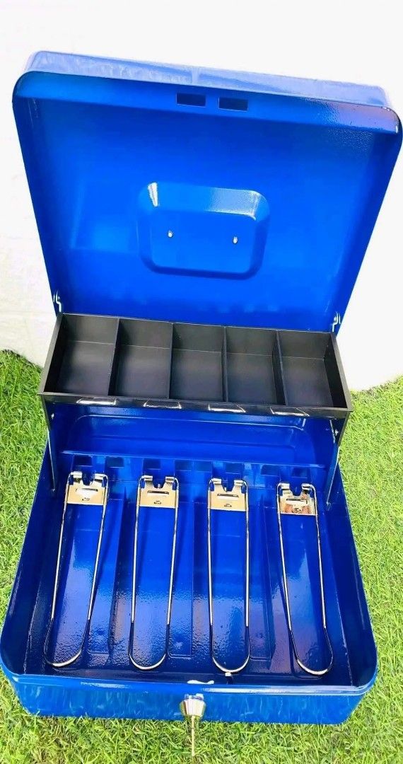 Cash box (Category: Storage Boxes & Baskets) located in Manila. Submitted by jelai.cybyb (Listing ID 1402049585, Image 3). Description: Metal cash box features a removable tray for organizing coins and a secure lock with a key. It has multiple compartments for bills and a separate section for smaller items. Available in black, pink, and blue. Perfect for small businesses, events, or personal use to keep your cash safe and organized..