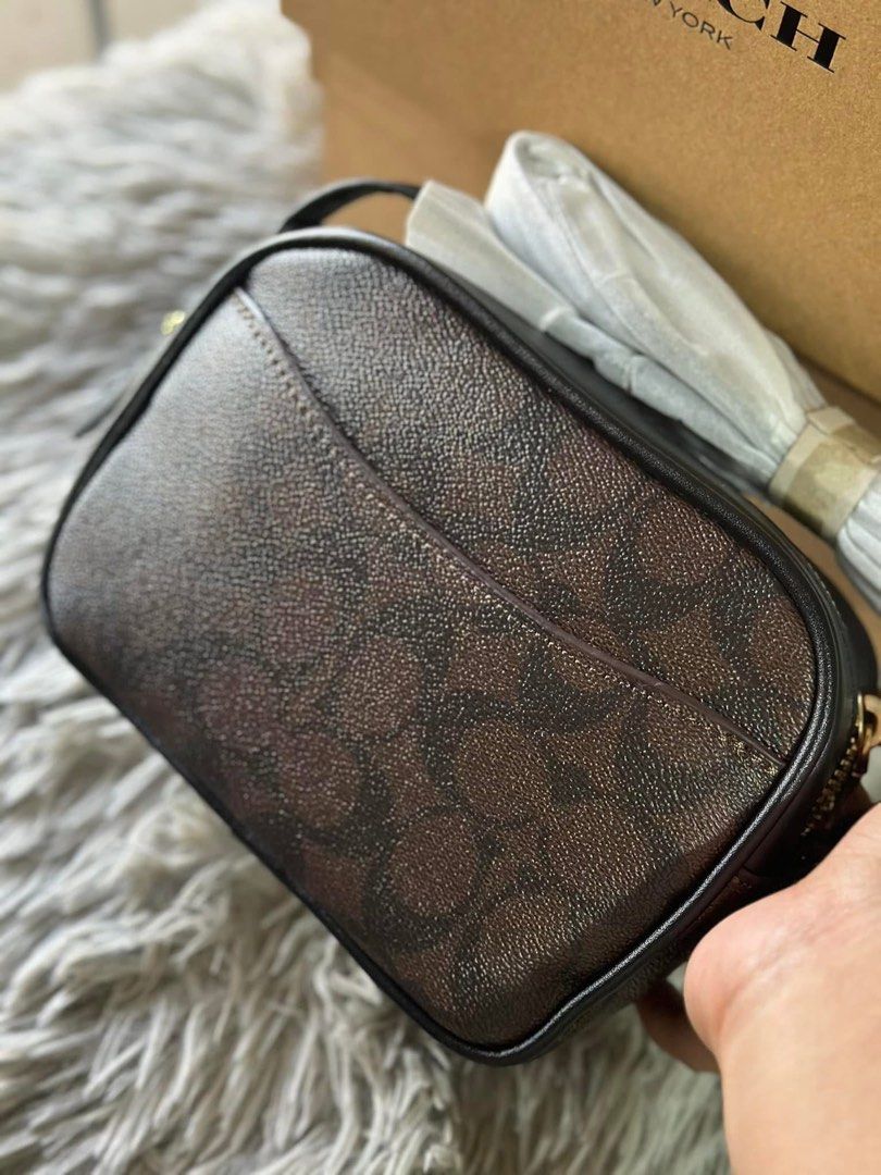 Coach Camera Bag Brown Signature with box (Category: Luxury Bags & Wallets) located in San Fernando. Submitted by smjhsmnlzcn (Listing ID 1402072209, Image 3). Description: - Coach camera bag - Brown signature print - Zip closure - Detachable strap - Gold-tone hardware - Coach logo on front - Includes original box.