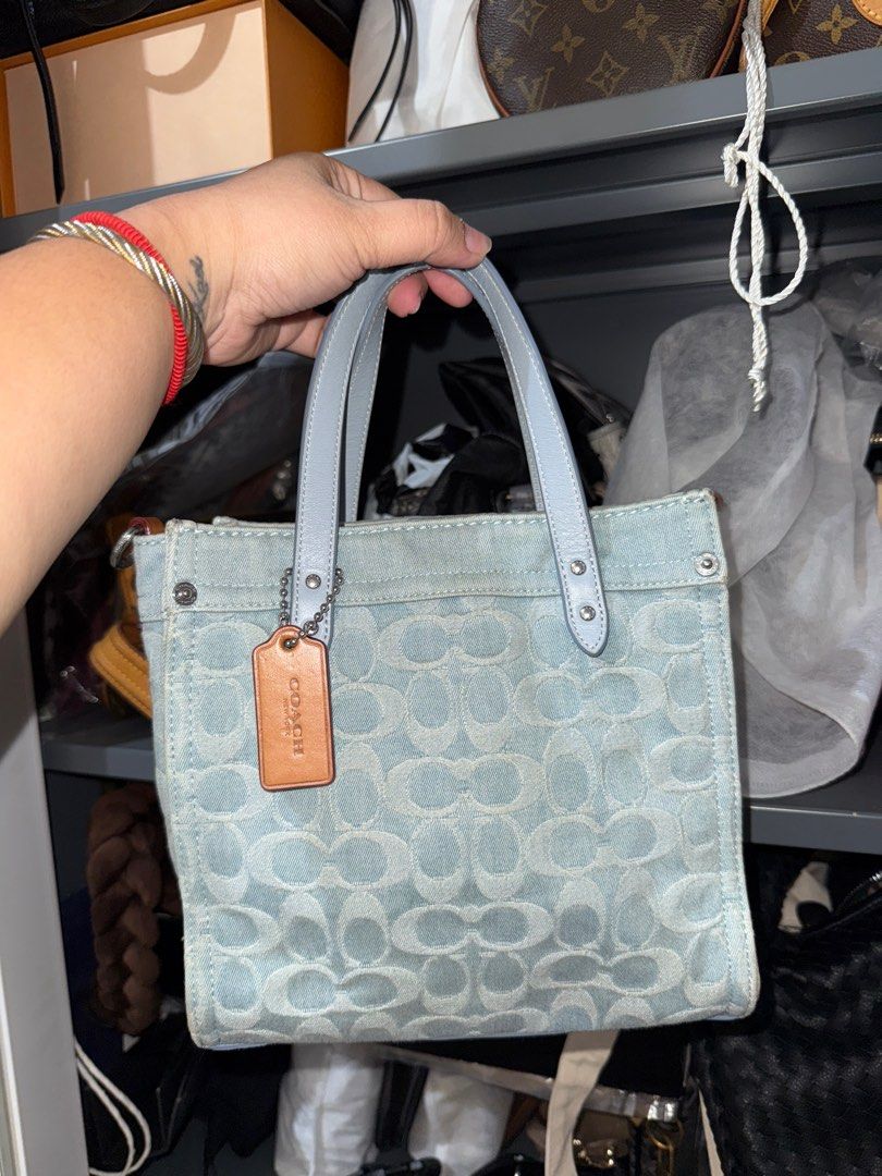 Coach Denim Tote Bag (Category: Luxury Bags & Wallets) located in San Juan City. Submitted by camyoo (Listing ID 1402073183, Image 1). Description: Coach tote bag features a denim exterior with a light blue leather handle and trim. The bag has a Coach tag and a spacious interior. The bottom of the bag is also light blue leather. No sling Last price already.