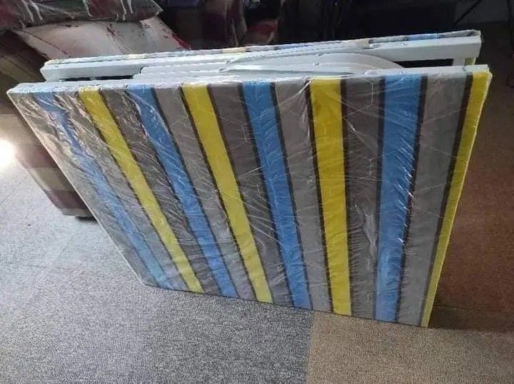 Folding Bed (Category: Bed Frames & Mattresses) located in Manila. Submitted by jelai.cybyb (Listing ID 1402048190, Image 3). Description: Folding bed features a striped mattress and a sturdy metal frame. It folds up for easy storage and transport. It's a practical solution for guests or for use in smaller spaces. The bed is easy to set up and fold away..
