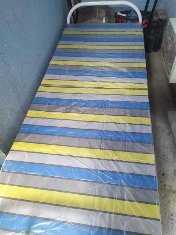 Folding Bed (Category: Bed Frames & Mattresses) located in Manila. Submitted by jelai.cybyb (Listing ID 1402048190, Image 2). Description: Folding bed features a striped mattress and a sturdy metal frame. It folds up for easy storage and transport. It's a practical solution for guests or for use in smaller spaces. The bed is easy to set up and fold away..