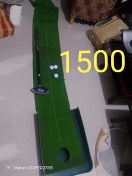 Golf Putting Mat with Putter and Balls (Category: Golf) located in Abucay. Submitted by jflshoppe1989 (Listing ID 1402093078, Image 1). Description: Golf putting mat with a putter and golf balls. The mat has a hole at the end for practice. The set includes a putter and golf balls. Perfect for practicing your putting skills at home..