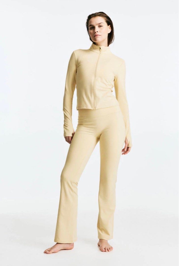 H&M MOVE Activewear Jacket in Softmove Butter Yellow (Category: Coats, Jackets and Outerwear) located in San Jose del Monte. Submitted by madamegazelle (Listing ID 1401952017, Image 3). Description: Beige zip-up jacket features a high collar and long sleeves with thumb holes. The jacket has a fitted silhouette and a full-length zipper. The MOVE logo is subtly embroidered on the back. Plus Size Activewear Jacket Butter Yellow Jacket XXL Plus Size 