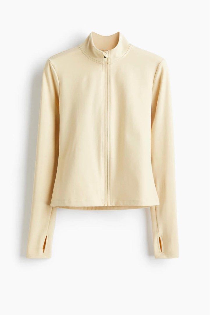 H&M MOVE Activewear Jacket in Softmove Butter Yellow (Category: Coats, Jackets and Outerwear) located in San Jose del Monte. Submitted by madamegazelle (Listing ID 1401952017, Image 2). Description: Beige zip-up jacket features a high collar and long sleeves with thumb holes. The jacket has a fitted silhouette and a full-length zipper. The MOVE logo is subtly embroidered on the back. Plus Size Activewear Jacket Butter Yellow Jacket XXL Plus Size 