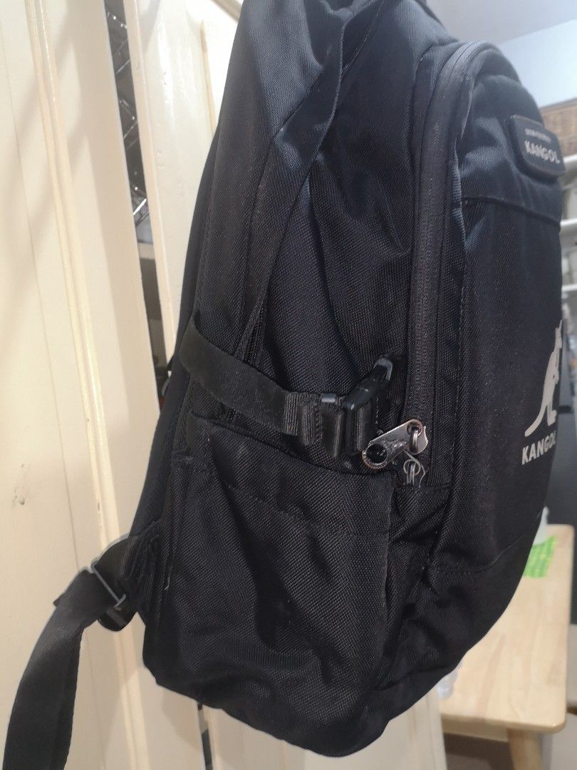 Kangol Backpack (Category: Backpacks) located in Quezon City. Submitted by jo_santos (Listing ID 1402082713, Image 2). Description: - Black Kangol backpack - Multiple compartments for storage - Features the iconic Kangol logo - Includes side pockets - Adjustable straps for a comfortable fit - Interior pockets for organization - Laptop compartment inside - Padded exterior back pack - Top handle for easy carrying - Clean, no issues - Length : 30 cm