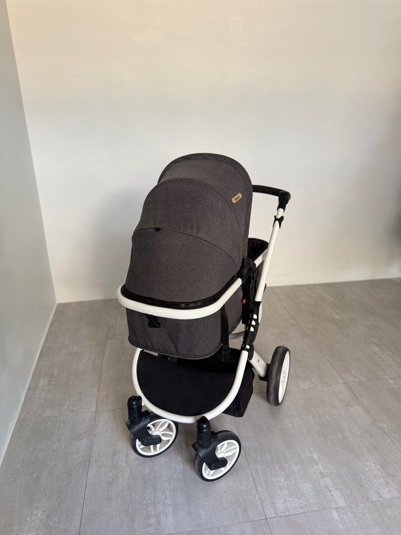 Looping Sydney Baby Stroller (Category: Strollers) located in Paranaque City. Submitted by prebyb (Listing ID 1401977612, Image 2). Description: Looping baby stroller with a dark grey canopy and seat. Features a white frame with black accents and wheels. Includes a storage basket underneath. The stroller has a reversible seat and adjustable handle. Some wear and tear is visible on the frame and handle. Please message me if you’d like to see more 