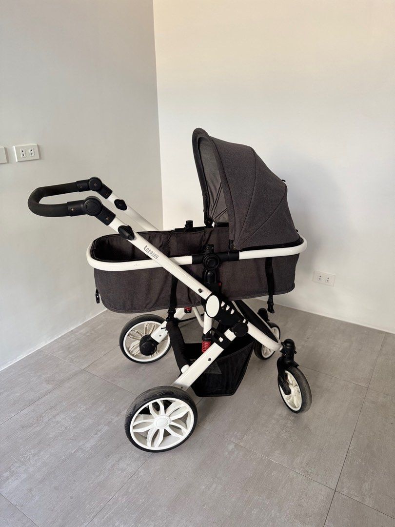Looping Sydney Baby Stroller (Category: Strollers) located in Paranaque City. Submitted by prebyb (Listing ID 1401977612, Image 3). Description: Looping baby stroller with a dark grey canopy and seat. Features a white frame with black accents and wheels. Includes a storage basket underneath. The stroller has a reversible seat and adjustable handle. Some wear and tear is visible on the frame and handle. Please message me if you’d like to see more 