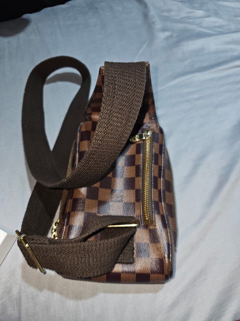 Louis Vuitton Damier Ebene Sling Bag (Category: Luxury Bags & Wallets) located in Tagbilaran City. Submitted by lugarpogi (Listing ID 1402027318, Image 3). Description: - Authentic Louis Vuitton Damier Ebene sling bag - Features the iconic brown and dark brown checkered pattern - Secure zippered main compartment with a stylish red interior - Adjustable strap for a comfortable fit - Elegant gold-tone hardware.