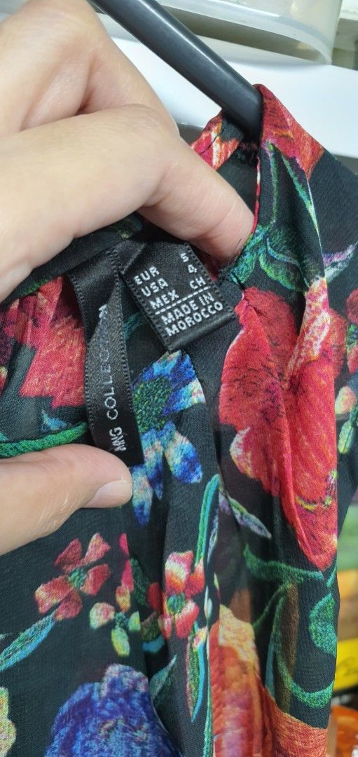 Mango Floral Sleeveless (Category: Sleeveless) located in Manila. Submitted by apoltree (Listing ID 1401961956, Image 3). Description: - Mango floral sleeveless - Size: S - Sleeveless design - Made in Morocco - Features a vibrant floral print on a black background - Suitable for casual and special occasions.