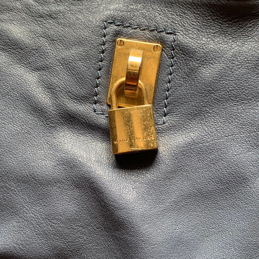Marc Jacobs Leather Handbag (Category: Luxury Bags & Wallets) located in Cavite. Submitted by pickednthrift64 (Listing ID 1401924316, Image 3). Description: - Authentic Marc Jacobs handbag - Blue leather exterior - Gold-tone hardware - Top handle - Zip closure - Padlock detail - RIRI zipper - Visible interior lining - Some wear on handle - Spacious interior.