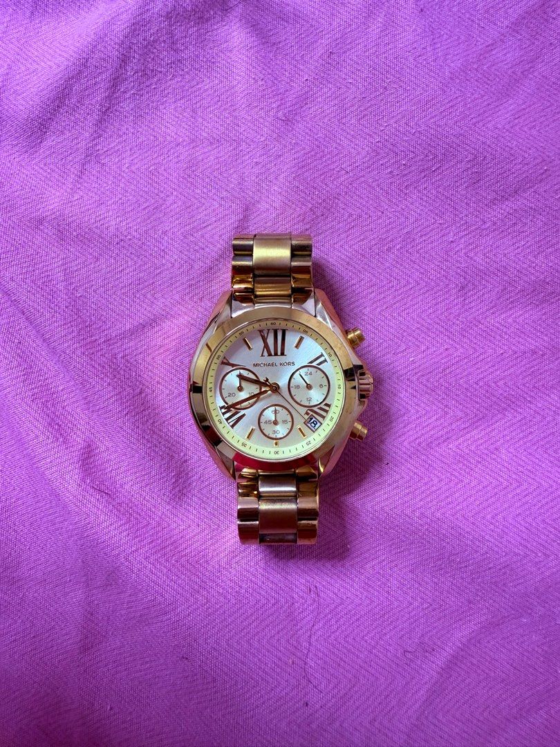 Michael Kors Gold Chronograph Watch original (Category: Luxury Watches) located in Quezon City. Submitted by Unida (Listing ID 1401930968, Image 1). Description: - Michael Kors gold watch - Chronograph dial with sub-dials - Roman numeral hour markers - Date display at 3 o'clock - Gold-tone bracelet.