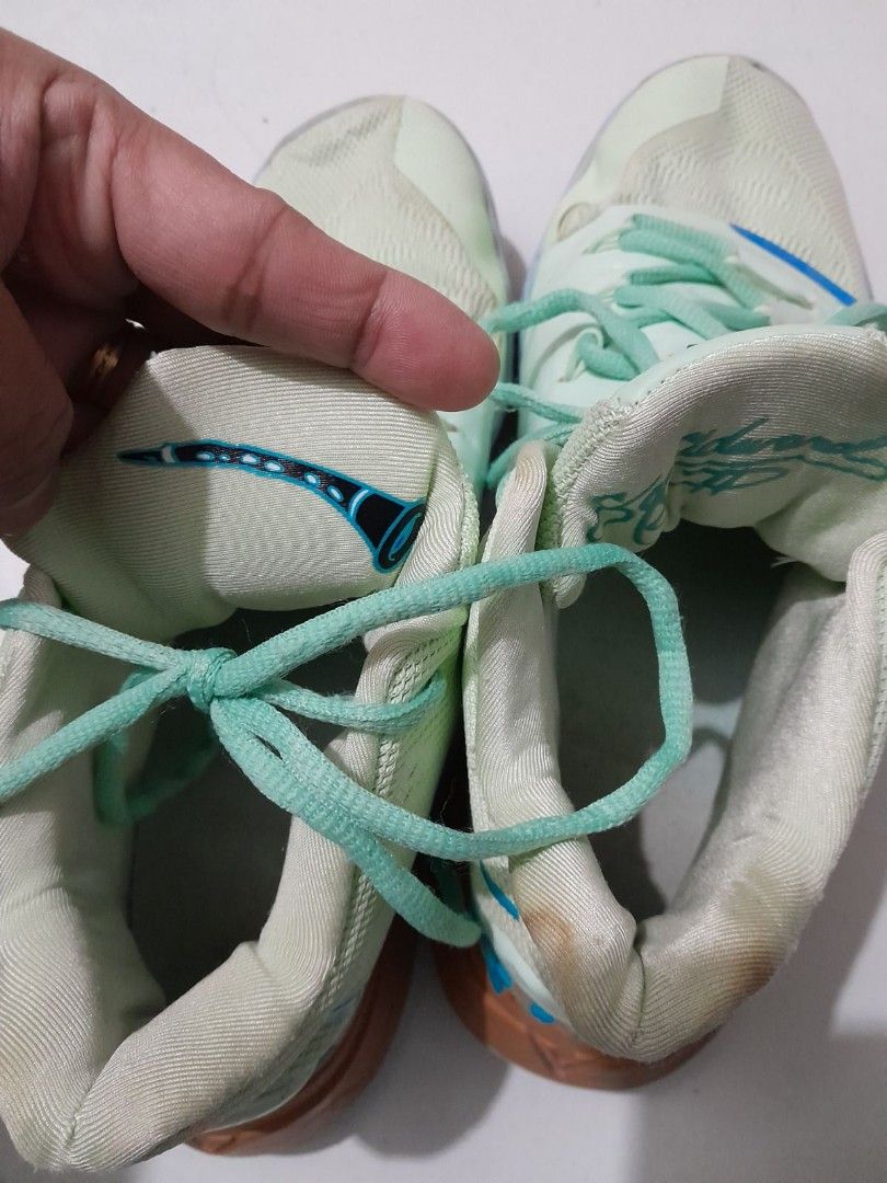 Nike Kyrie 5 Nickelodeon Squidward (Category: Sneakers) located in Calamba. Submitted by ysabellascloset17 (Listing ID 1402027075, Image 3). Description: Nike Kyrie 5 sneakers in a light green and blue colorway. Features the Nickelodeon Squidward design. The shoes have a high-top design with the Nike logo on the side and the "K" logo on the tongue. The soles are a mix of purple and blue. The size is US 9..