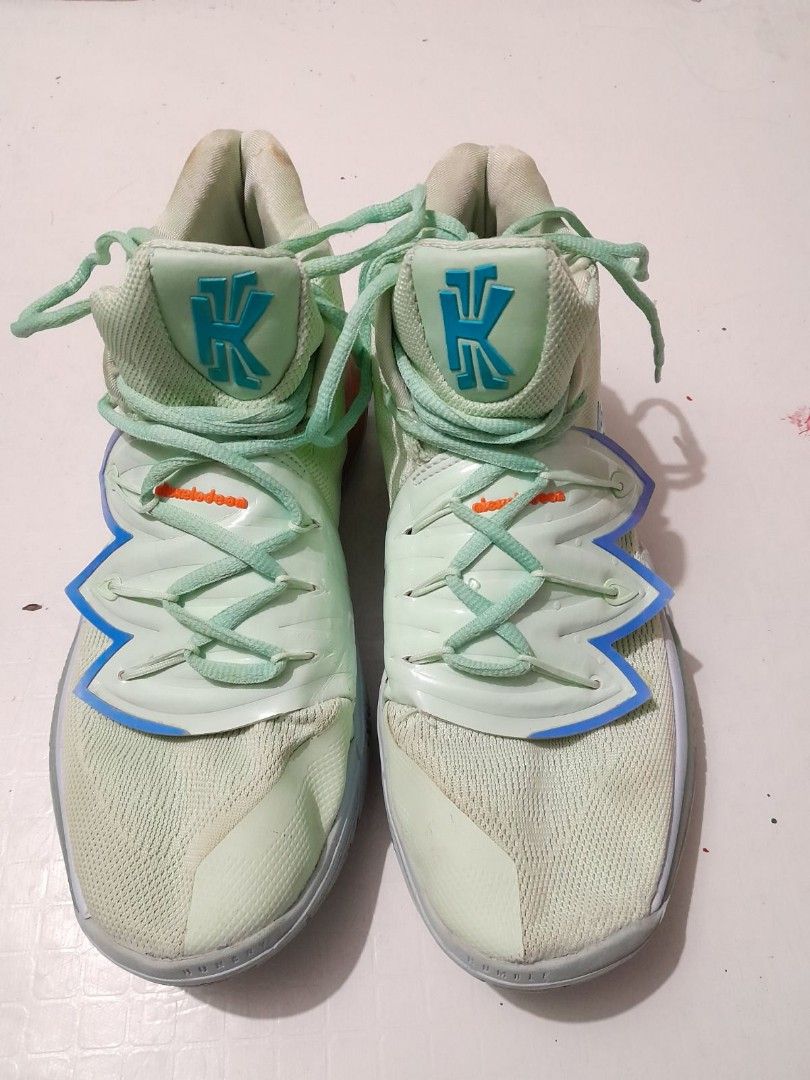 Nike Kyrie 5 Nickelodeon Squidward (Category: Sneakers) located in Calamba. Submitted by ysabellascloset17 (Listing ID 1402027075, Image 2). Description: Nike Kyrie 5 sneakers in a light green and blue colorway. Features the Nickelodeon Squidward design. The shoes have a high-top design with the Nike logo on the side and the "K" logo on the tongue. The soles are a mix of purple and blue. The size is US 9..