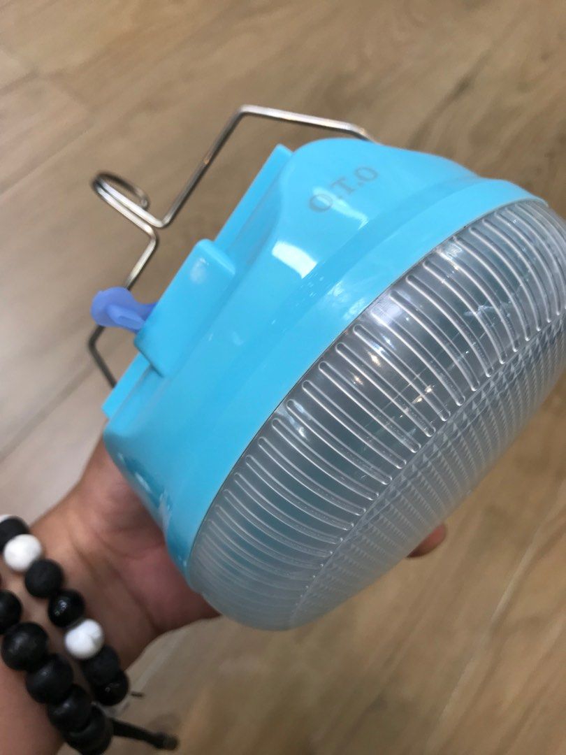 O.T.O Solar Powered LED Camping Lamp - 200W (Category: Lighting) located in Manila. Submitted by o.t.o_solar_xinmey_lighting (Listing ID 1401945632, Image 1). Description: O.T.O camping lantern features solar charging and a large capacity battery. It has a metal hook and magnetic suction for easy hanging. The sealed lamp body ensures durability. It is ideal for camping and outdoor activities. The lantern is blue and has a clear, ribbed light diff
