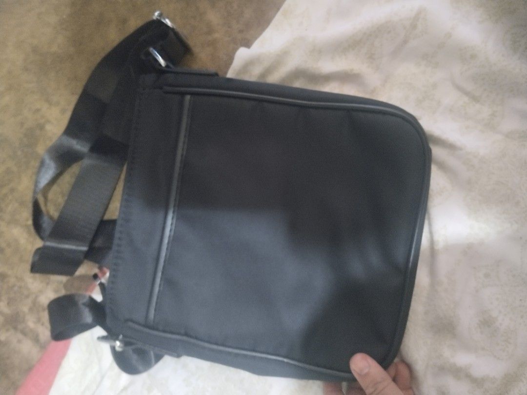 Prada Black Messenger Bag (Category: Luxury Bags & Wallets) located in Alaminos. Submitted by osaj55756 (Listing ID 1401919049, Image 2). Description: - Authentic Prada messenger bag - Classic black nylon material - Features the Prada logo - Adjustable shoulder strap for comfort - Secure zipper closure.